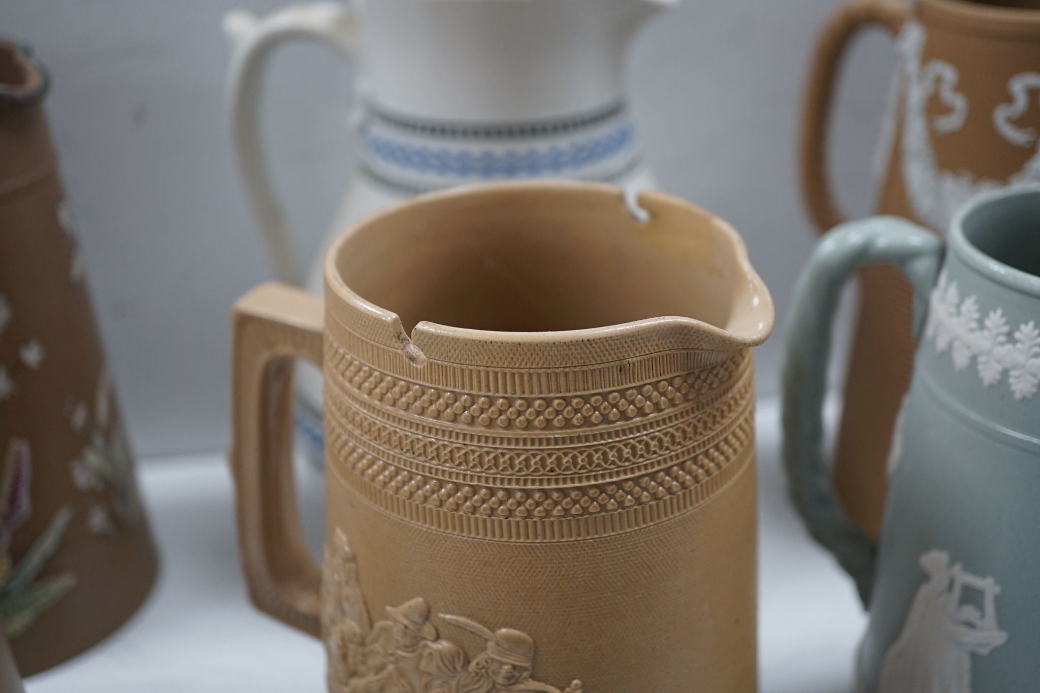 A collection of Dudson stoneware, including jugs, teapots, cream jugs etc, many decorated in low relief